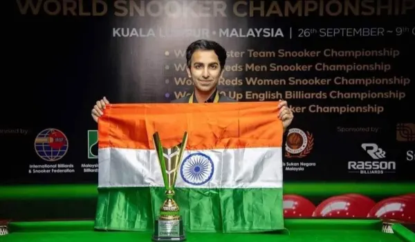 Pankaj Advani holding the Indian flag with a champion's trophy