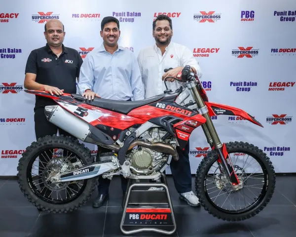Team owners and ISRL officials with the PBG Ducati Legacy Racing Ducati motocross bike