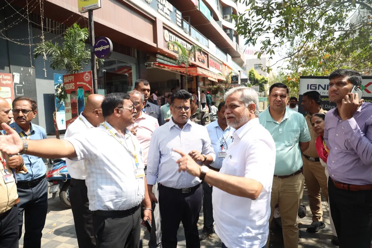 PMC officials inspect encroachments on a road to the airport in Viman Nagar