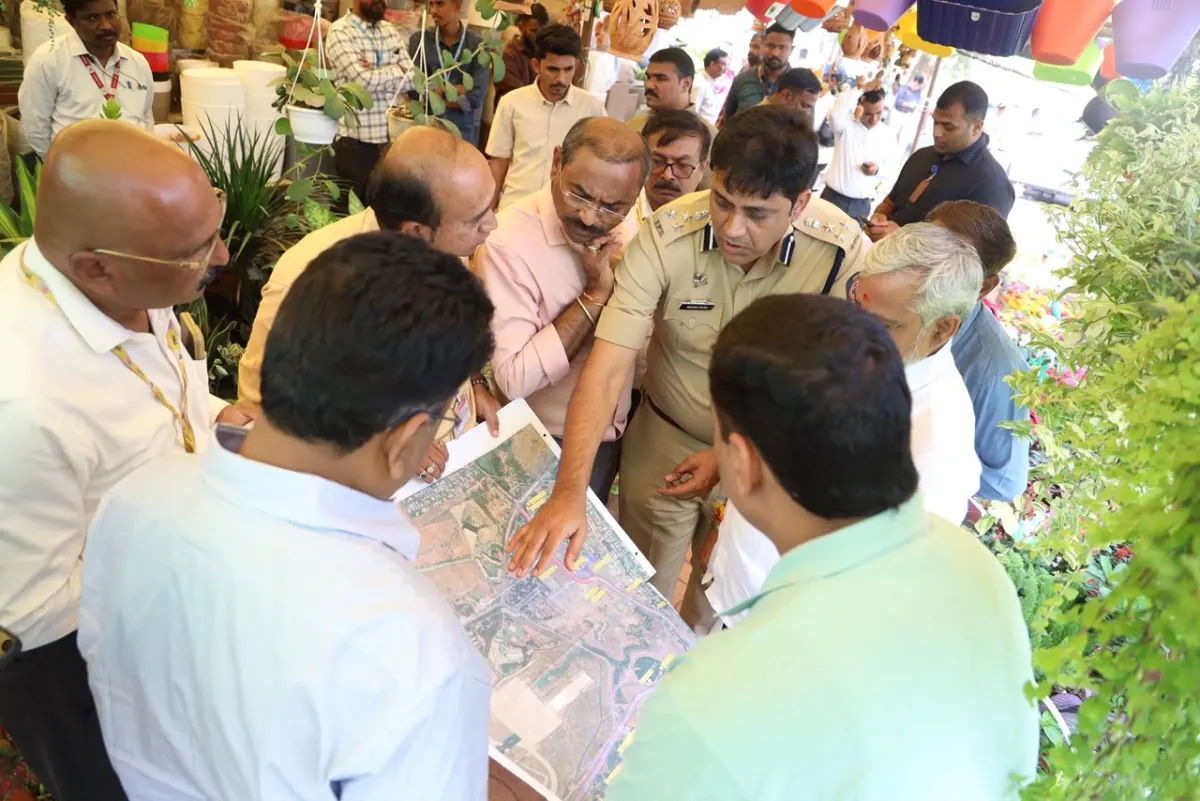 Officials study the map of the roads to Pune Airport during the inspection