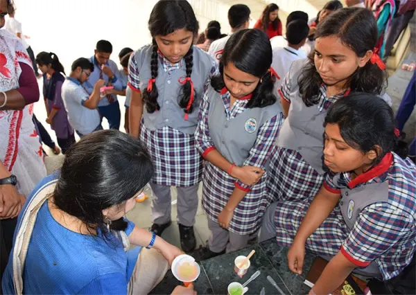 School girls doing a science experiment at a VigyanShaala workshop